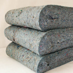 Three folded stacks of the speckled grey Quiet Batt® Soundproofing insulation