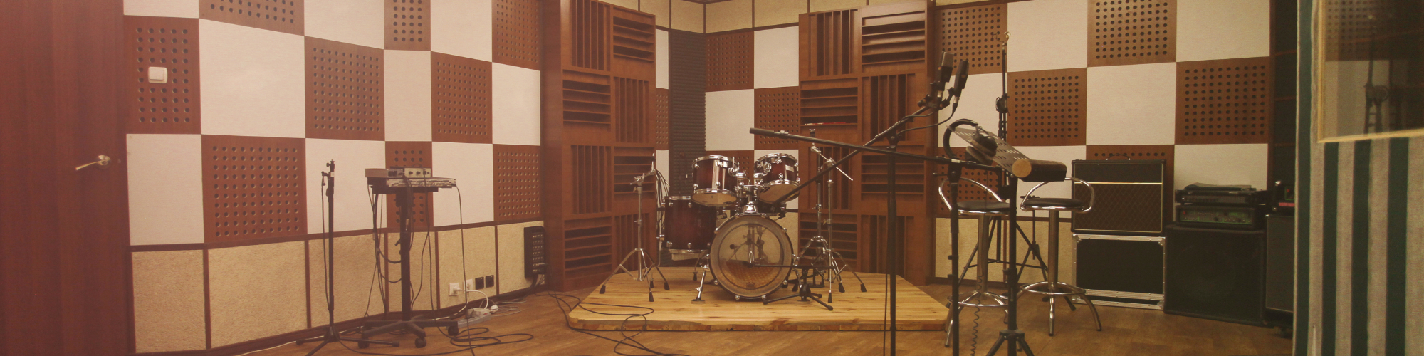 music room with drums, microphones and soundproof panels