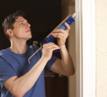 man installing caulking