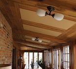 A slanted wooden roof with spaced out acoustic soundproofing panels that match the interior